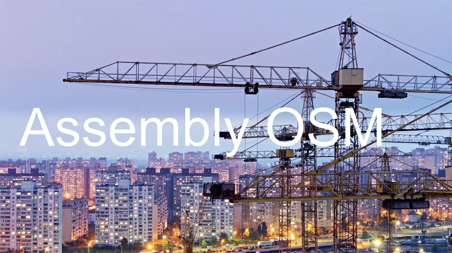 Three cranes in a row in front of a city skyline