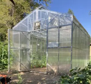 Exterior view of a B&T Manufacturing steel-framed greenhouse