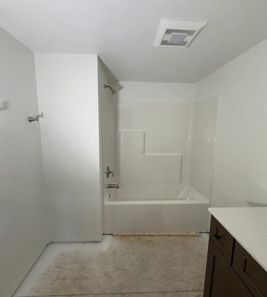 Interior view of florless bathroom shower and bathtub bathroom pod